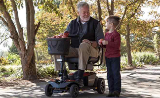 old man on mobility scooter with boy